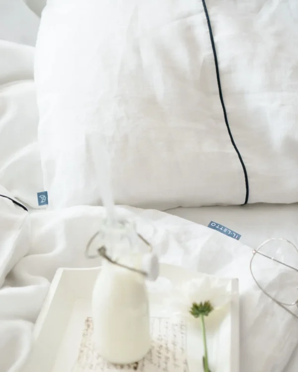 White linen pillowcase with navy blue piping - Image 1